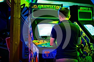 PRAGUE - CZECH REPUBLIC, August 5, 2017 - Young man playing an old vintage arcade game