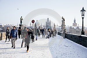 Prague, Czech Republic, 15 December 2022: Old town bridge towers with spire, River Vltava, View from Charles bridge, snow on sunny