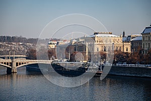 Prague, Czech Republic, 15 December 2022: Old town with towers above River Vltava, View from Charles bridge, snow on roof at sunny