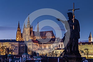 Prague, Czech Republic - Illuminated St.Vitus Cathedral at dusk with clear blue sky taken from Charles Bridge