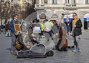 Prague, Czech Republic - March 13, 2017: Quartet of Musicians playing musical instruments for tourists on the street in Prague