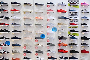 PRAGUE, CZECH REPUBLIC - MAY 2017: Lots of different sneakers on the showcase on market. Image of sport shoes on shop-window