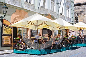 PRAGUE, CZECH REPUBLIC - MAY 2017: Tourists outside cafe, restaurant in the old town of Prague.