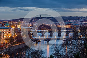 Prague, Czech Republic - Panoramic skyline of the city of Prague at dusk with blue clouds and Charles Bridge