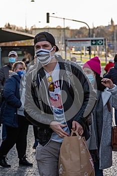 People on a winter day facing quarantine. Man, woman, mums, child, old and young people outdoors. Prague 6