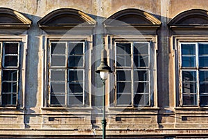Prague, Czech republic - September 19, 2020. Architectonic details of building in Pohorelec street - old windows with street lamp