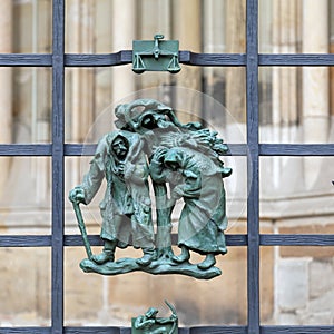 Prague, Czech Republic - September 23, 2019. A copper bas-relief on the fence of St. Vitus Cathedral depicting rural life