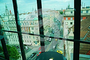 Through window view European city buildings on street below