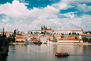 Prague, Czech Republic. Sightseeing Boat Sailing Along Vltava River On Background Upper Town.