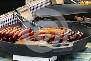 Prague, Czech Republic 2019:Traditional hot dog preparation on coal fire on the street during the Christmas market