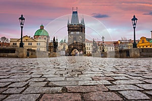 Prague, Czech Republic - The world famous Charles Bridge Karluv most and St. Francis Of Assisi Church with beautiful purple sky photo
