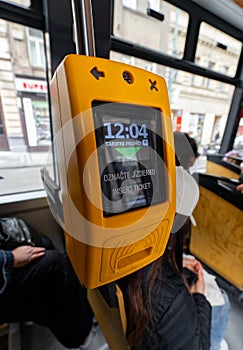 Yellow ticket validator inside Prague tram