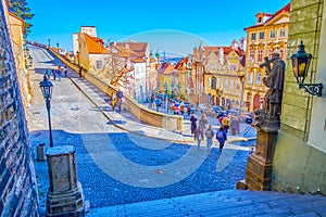 Tourists walk along the descent leadoing to Prague Castle from lower Mala Strana district in Prague, Czechia