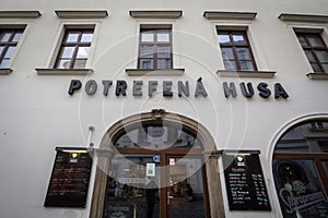 Potrefena Husa logo in front of their local restaurant in Prague.