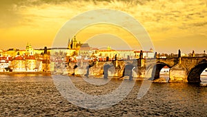Prague Hradcany Panorama on golden sunny day. Charles Bridge over Vltava River with Prague Castle, Czech Republic