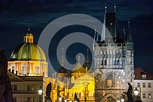 Prague at night, towers of Saint Nicholas by the Charles bridge