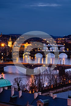 Prague at night, view of bridges on the Vlatava river, reflection of night city lights, cityscape