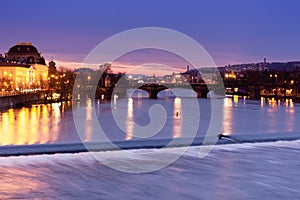 Prague at night, view of the Vlatava river, reflection of night city lights, cityscape