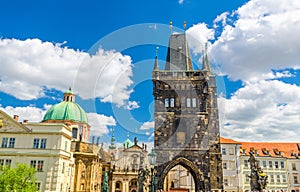 Prague Old Town Bridge Tower on Charles Bridge Karluv Most over Vltava river, St. Salvator Church in Klementinum