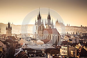 Prague towers of Old Town with Tyn church aerial view and Prague Castle, sunset, golden light, travel to Prague