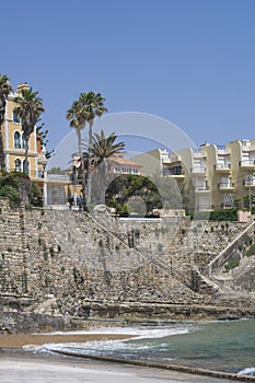 Praia da Azarujinha, beach in Estoril, portugal. hill, houses, stairs near ocean