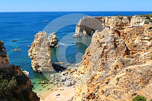 Praia da Marinha beach and Arco Natural double arch cliffs in Algarve photo