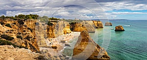 Praia da Marinha, beautiful beach Marinha in Algarve, Portugal. Navy Beach (Praia da Marinha) with flying seagulls