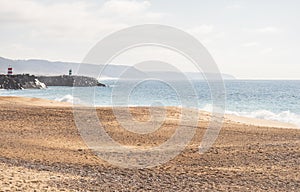 Praia da NazarÃ© beach with rough sea in Portugal, soft colors