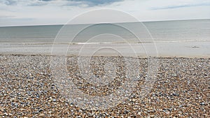 Colorful stone beach in Newhaven, clean blue water, England just beautiful! photo