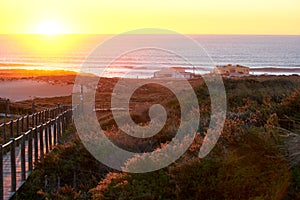 Praia do Guincho Beach and Hotel Fortaleza on a summer day in Sintra, Portugal