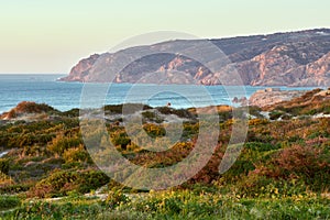 Praia do Guincho beach sand dunes and the coastline at sunset