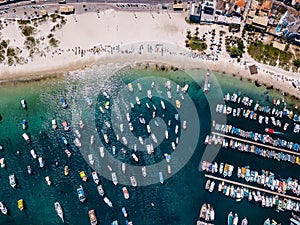 Praia dos Anjos in Arraial do Cabo Brazil. City beach and fishing boats. Beautiful sunny day. Colorful aerial dron photo