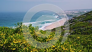 Praia grande sandy beach with tourists on Atlantic ocean, Sintra, Portugal, Europe