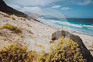 Praia Grande. Spectacular sand dunes, ocean waves and black volcanic stones. Barren landscape of Calhau, Sao Vicente