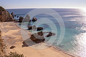 Praia Ribeira do Cavalo, a hidden beach of crystal clear blue waters near the town of Sesimbra photo