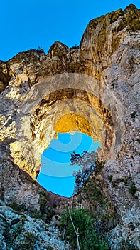 Praiano - Woman standing in the rock formation Montepertuso Il Buco in Positano and Praiano, Amalfi Coast, Campania, Italy, Europe