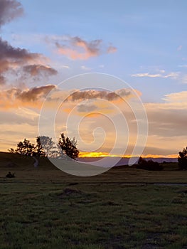 Prairie field and cloud in the spring sunset