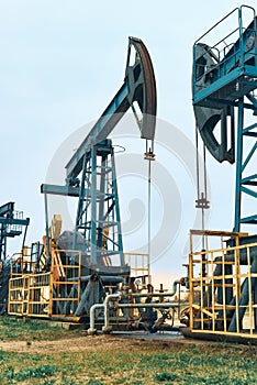 Prairie Oil Pump Jacks. Crude oil is a major economic driver. Themes in the image include geology, engineering, pump