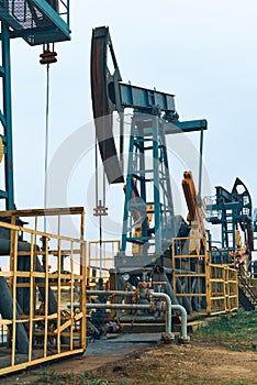 Prairie Oil Pump Jacks. One pump jack producing oil. Crude oil is a major economic driver