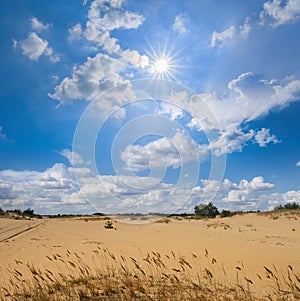 Prairie under a cloudy sky and hot sparkle sun