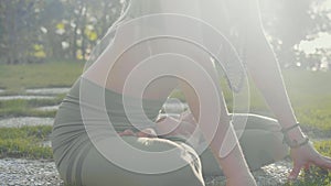 Pranayama yoga breath exercise by a young woman in the backyard of her house.