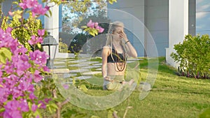 Pranayama yoga breath exercise by a young woman in the backyard of her house.
