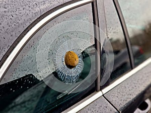 a prank ball shot into a car window and shattered glass in the form of a