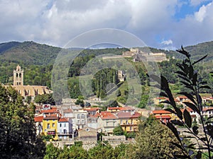 Prats-de-Mollo with church of Saint-Juste-et-Sainte-Ruffine, Fort Lagarde, and mountains, Pyrenees Orientales, southern France