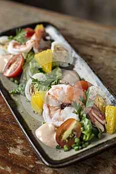 Prawn and egg salad on rustic wood table