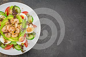 Prawn salad with cucumber and avocado, seeds, vegetables, lettuce