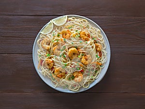Prawn Schezwan Noodles with vegetables in a plate