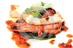 Prawn seafood dish serve with sauce and vegetable on top