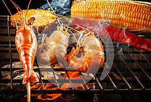 prawn ,shrimp grilled on barbe-que fire stove with pineapple ,red chilly and corn