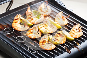 prawn skewers with lime on electric grill